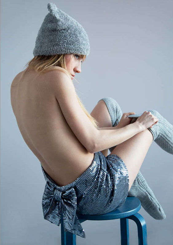 Stunning girl in winter cap sitting on the chair, by Magdalena Czajka